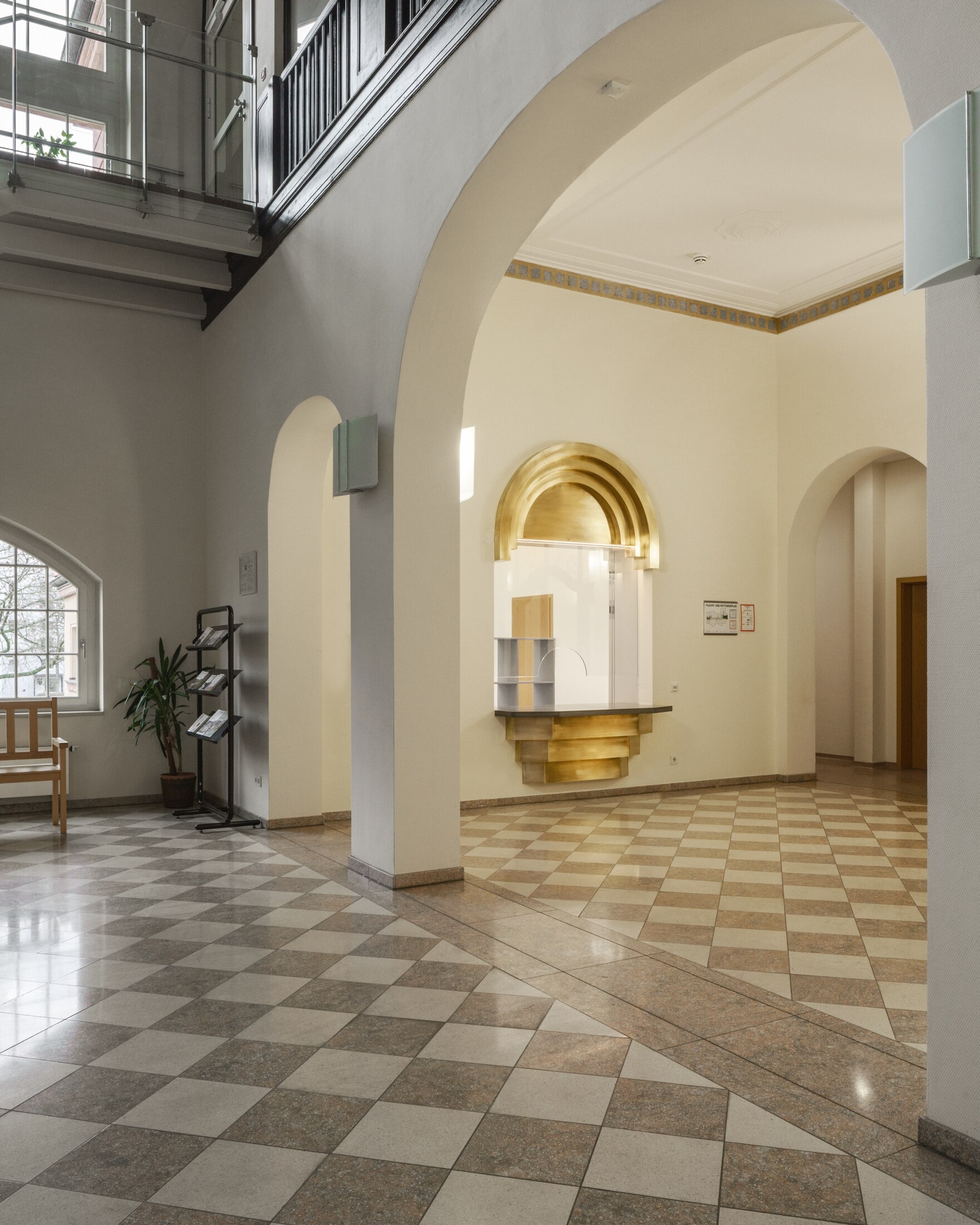 Im sanierten Eingangsbereich sticht die Kanzel mit ihren golden-schimmernden Messingelementen deutlich hervor.