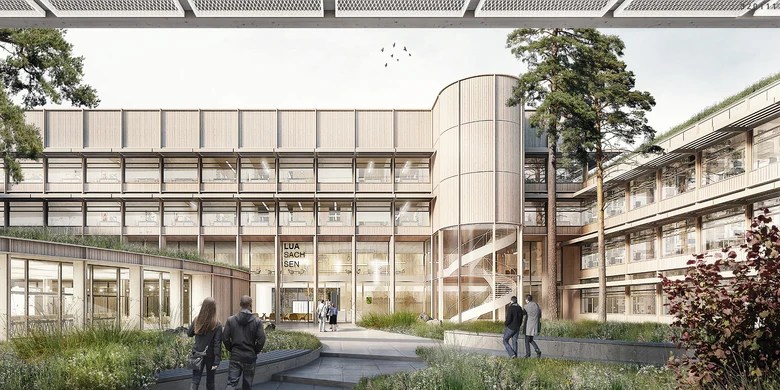 Zu sehen ist der erste Platz des Wettbewerbs. der Entwurf stellt den Innenhof der Geb&auml;udekomplexes dar mit viel Begr&uuml;nung entlang der Gehwege und der Dachfl&auml;chen.  Die Fassaden bestehen aus vielen und gro&szlig;z&uuml;gig geschnittenen Fenstern und Holzelementen.